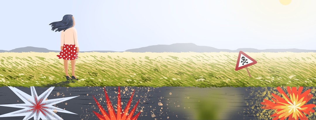 A person stands at the edge of a field that appears serene from above but the viewer can see that below lies undetectable and unexpected potential explosions.