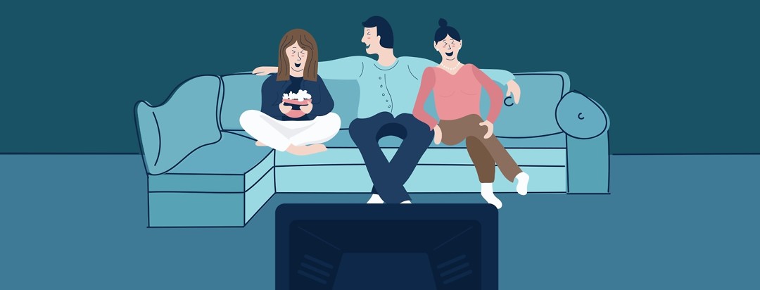 Three friends sitting on a couch watching a movie.