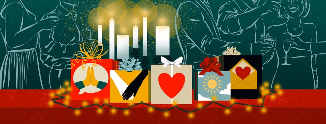 A collection of wrapped gifts portraying symbols of gratitude are gathered on a table, surrounded by Christmas lights and in front of a row of candles. Behind the gifts are people at an office party.