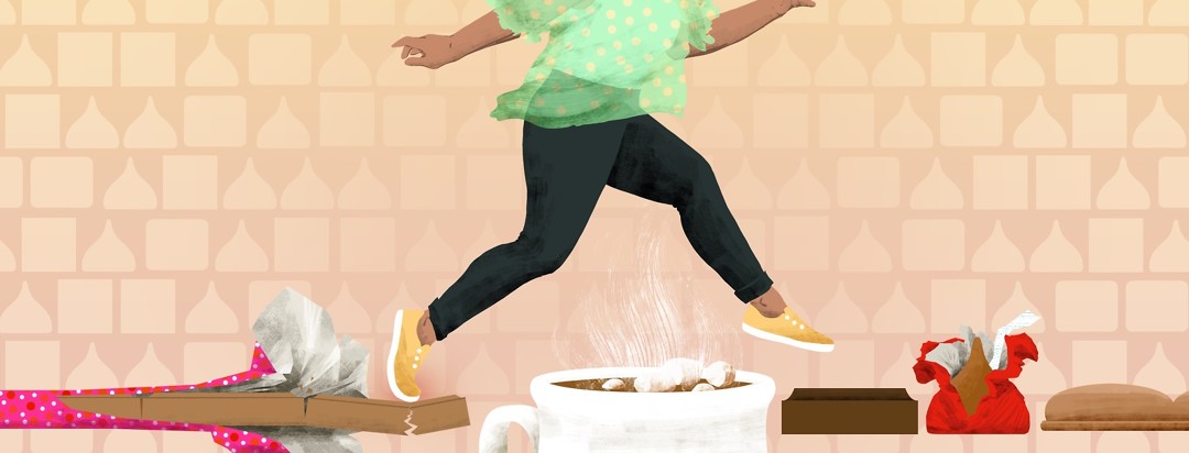 A woman lightly jumps from a cracking bar of milk chocolate over a mug of hot cocoa, onto a square of dark chocolate.