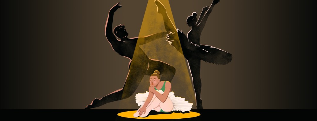 A sad ballerina sits on the floor with her eyes closed as a spotlight shines down on her. Behind her are the silhouettes of two other ballerinas dancing aggressively at each other.