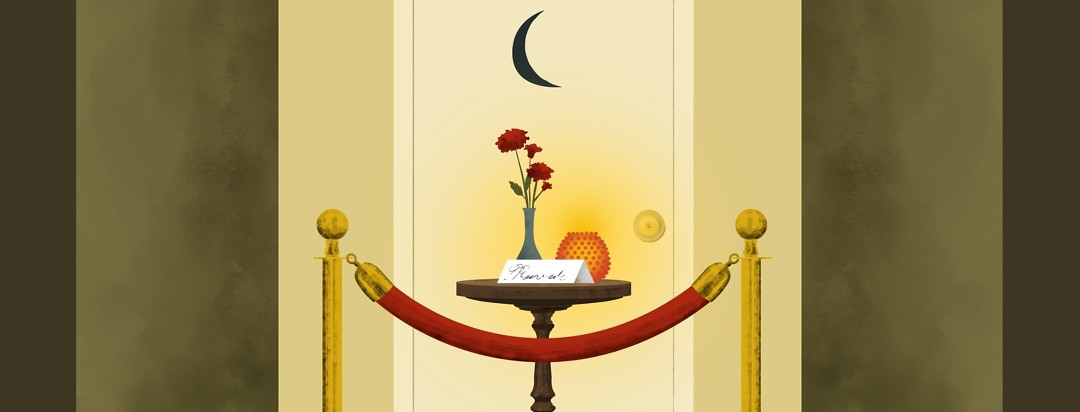 A private bathroom door has a velvet rope across the door and a small table with a small bouquet of flowers, a candle, and a "Reserved" card on it.