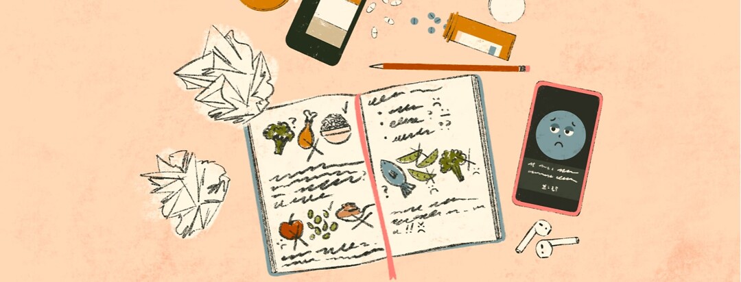 alt=an open journal with drawings of foods and notes is in the middle of crumpled up papers, a pencil, overturned medicine bottles with pills spilling out, and a phone with an app open on the screen.
