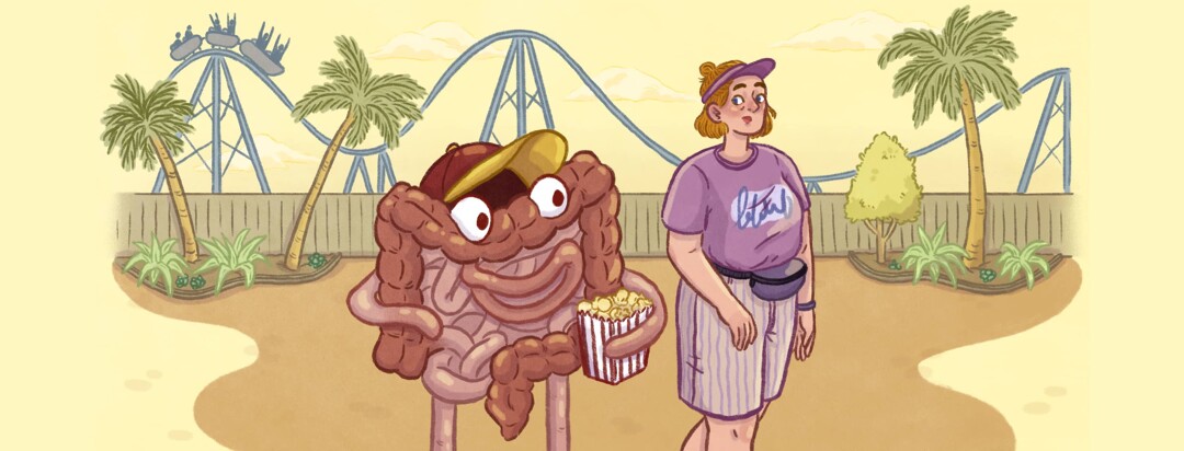 A woman walking in an amusement park with a roller coaster in the background is followed by anthropomorphized bowels wearing a hat and holding popcorn