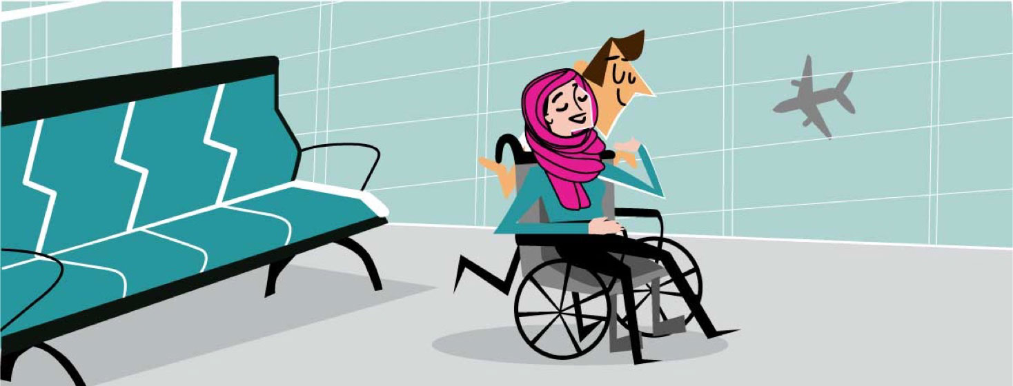 A man pushes a woman with a hijab in a wheelchair in the airport