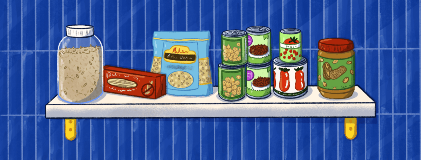 A shelf containing rice, pasta, oats, cans of chickpeas and lentils, canned tomatoes, and peanut butter