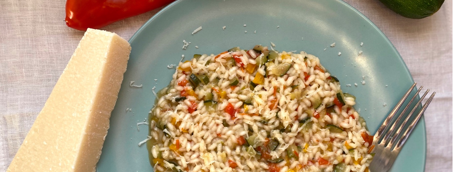 Spring Risotto next to cheese and a red and green pepper