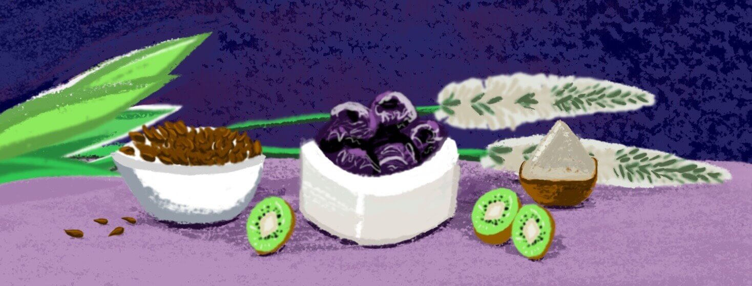 A psyllium husk, a bowl of prunes, a bowl of ground psyllium husk, kiwis, and a bowls of flax seeds on a purple table