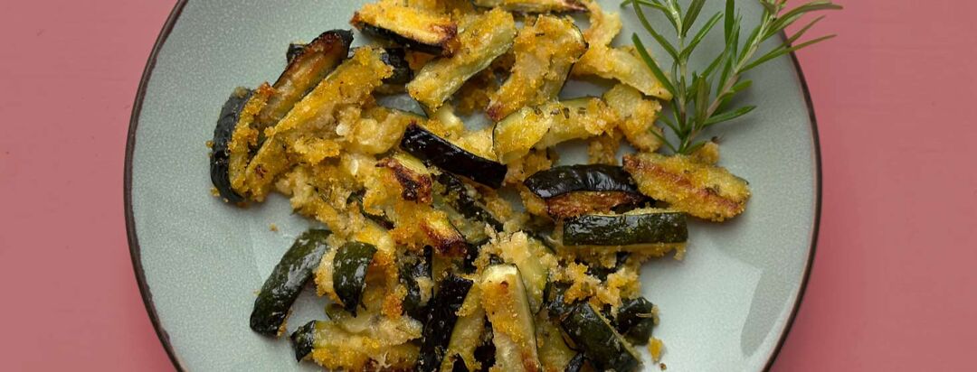 Image of sandy Zucchini on plate with rosemary garnish